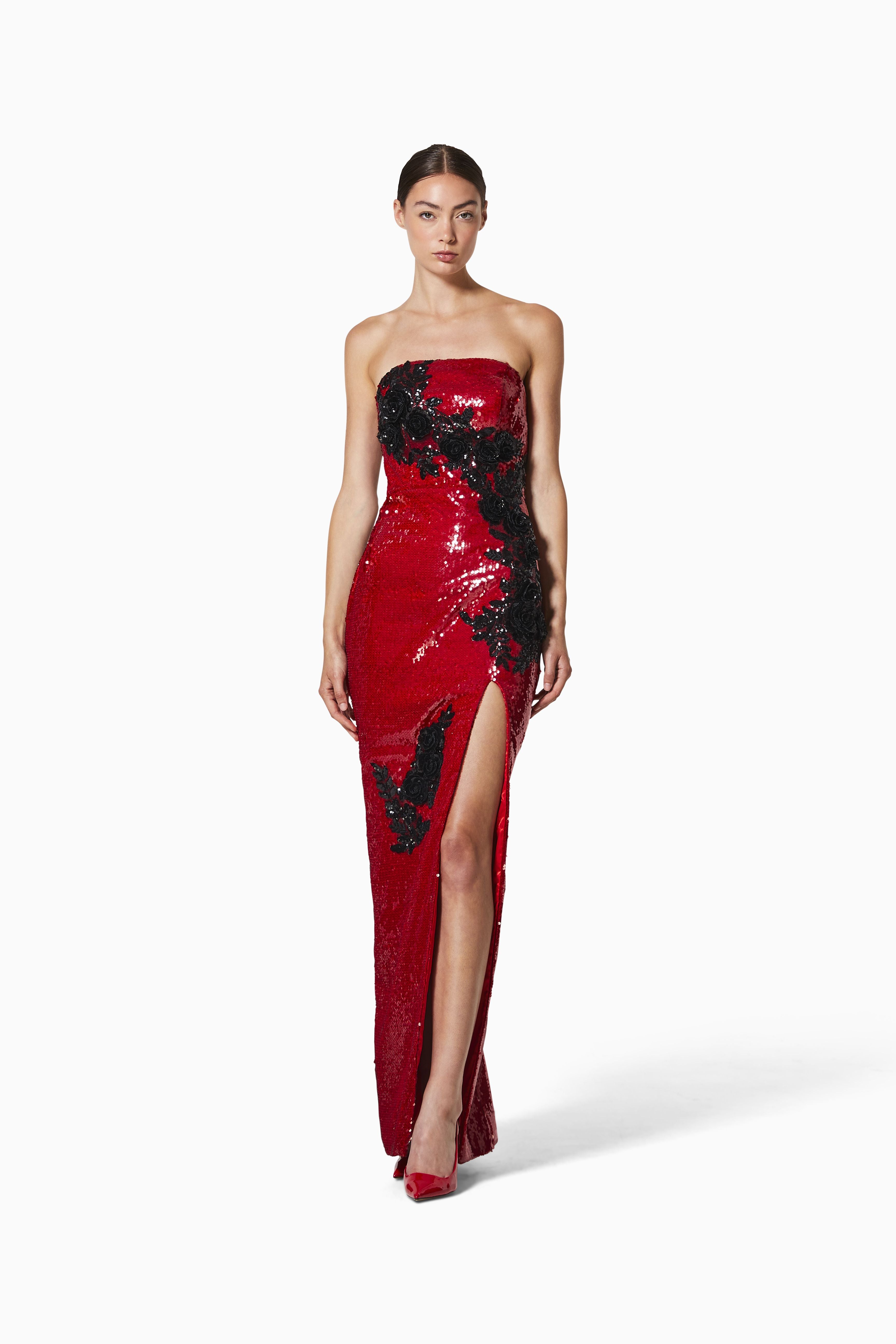 Red strapless gown with black sequin details on a white background