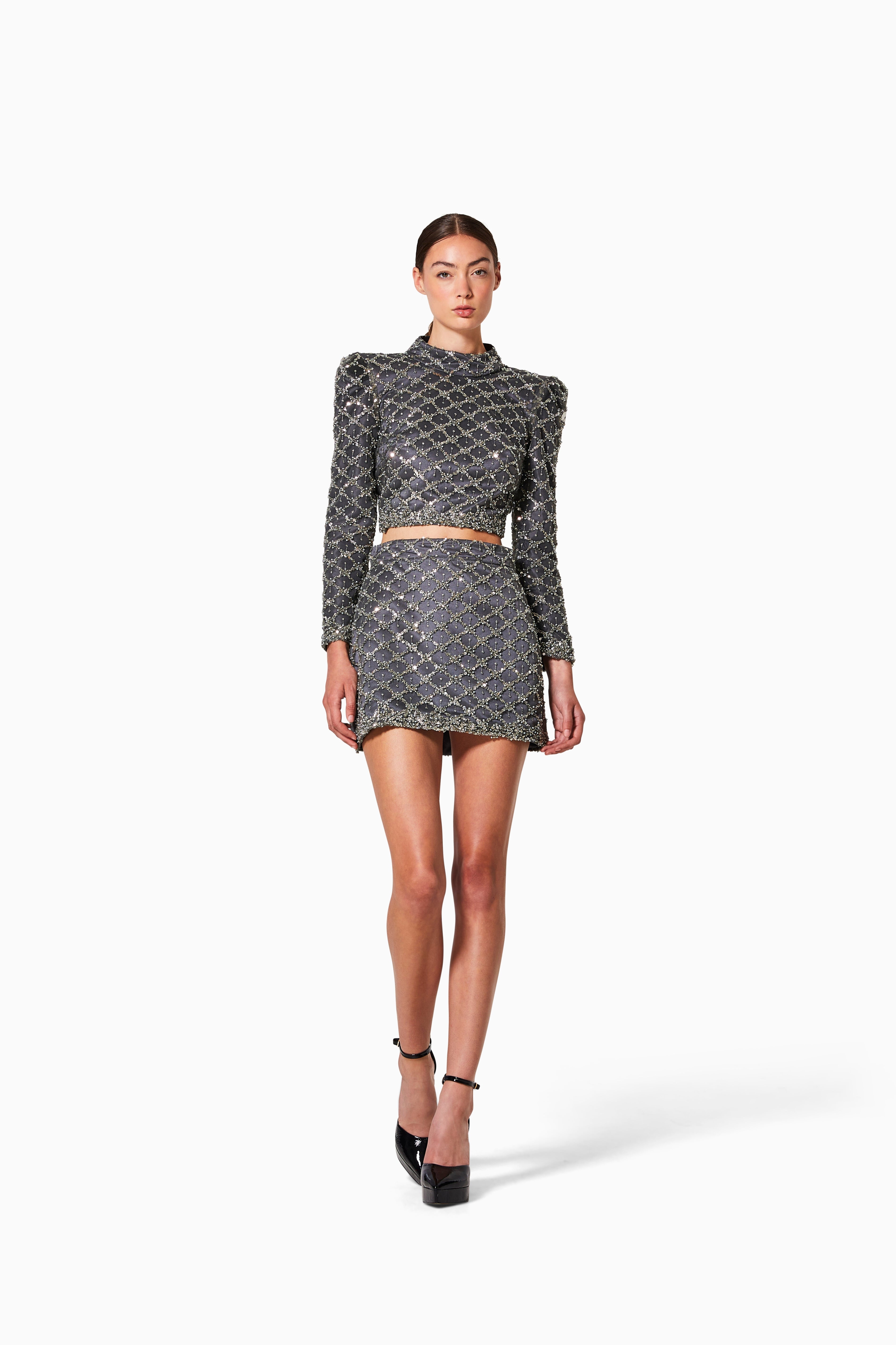 Woman wearing a patterned outfit on a white background