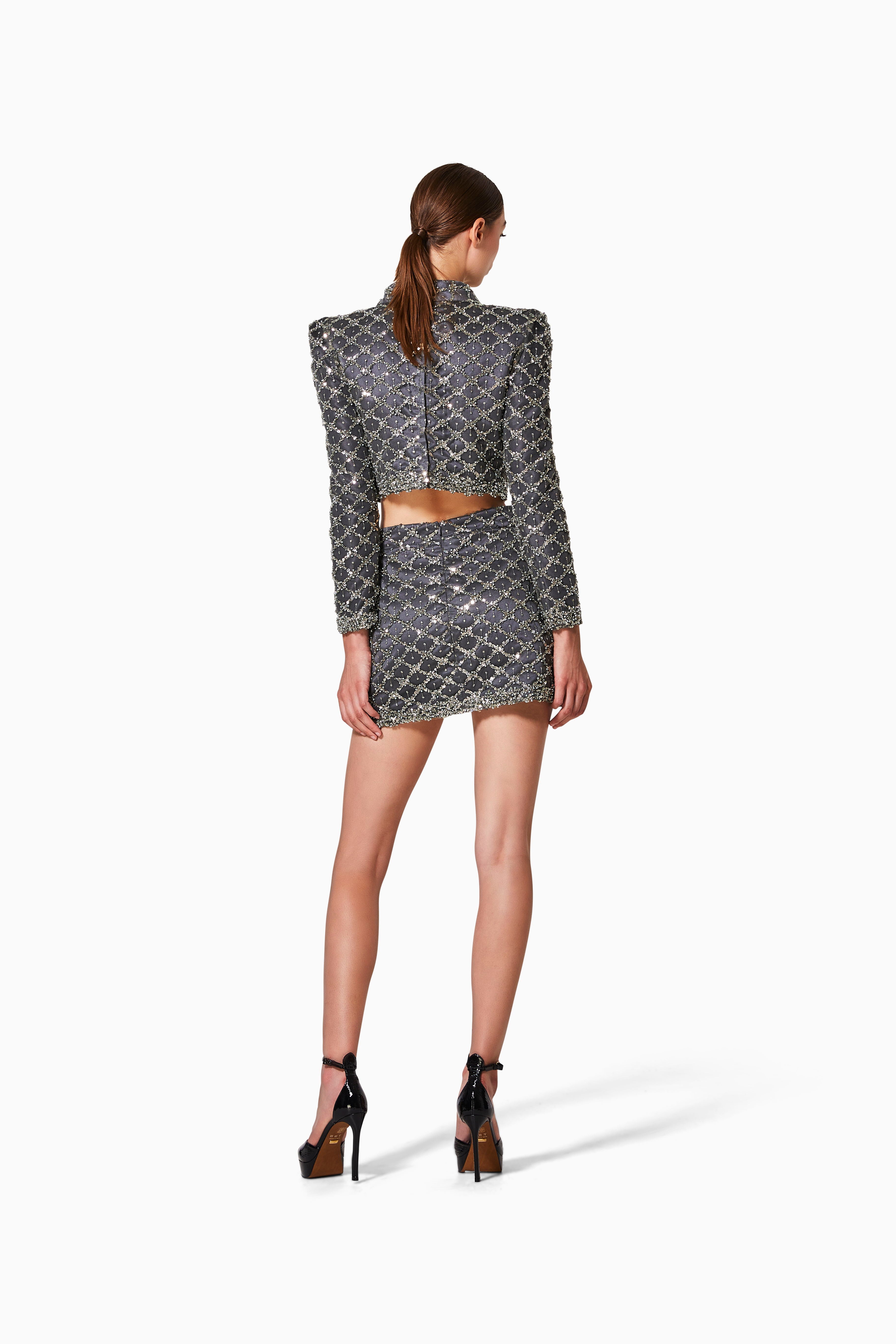 Woman wearing a patterned outfit on a white background