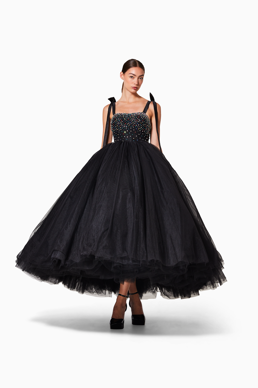 Black evening gown with beaded top and tulle skirt on a white background