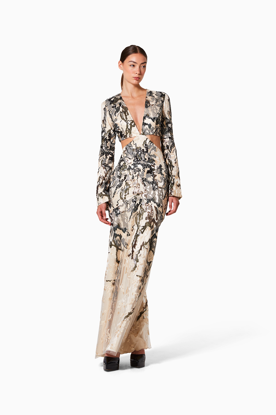 Woman wearing a floral dress with a cutout design on a white background