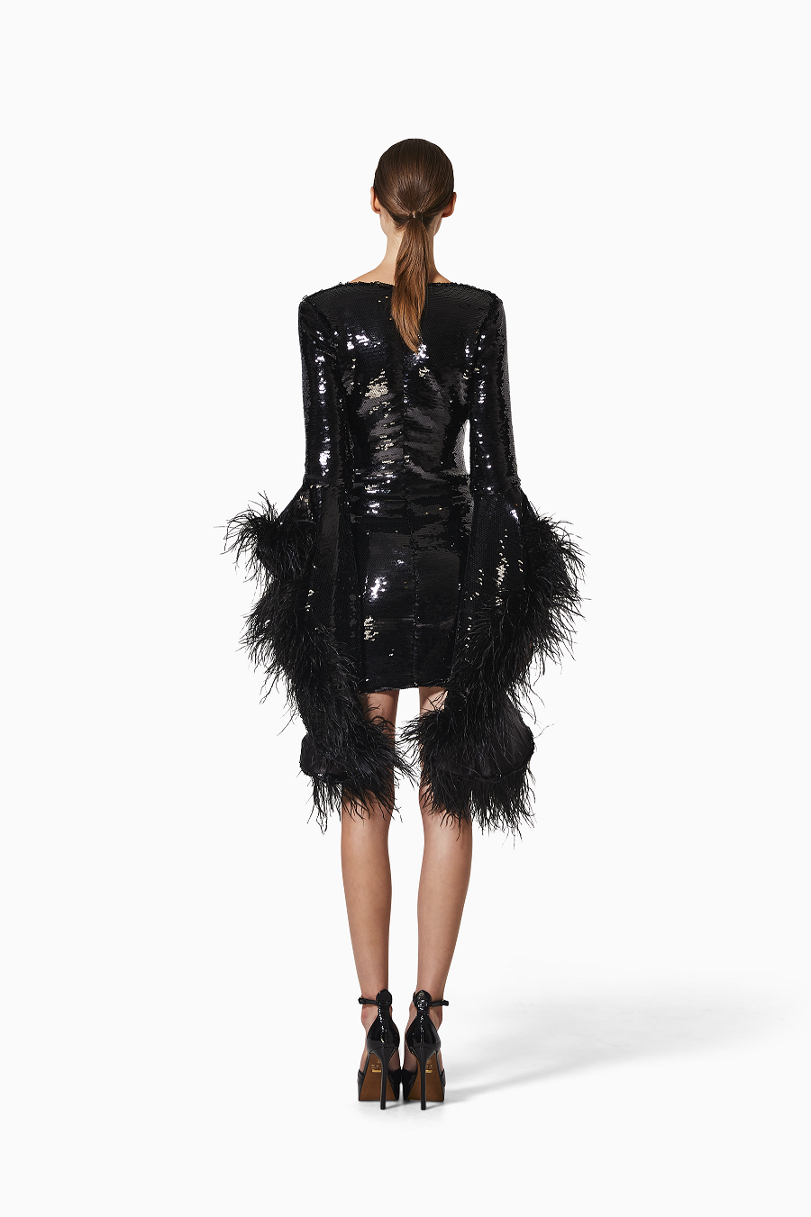 Black sequin dress with feather details on a white background