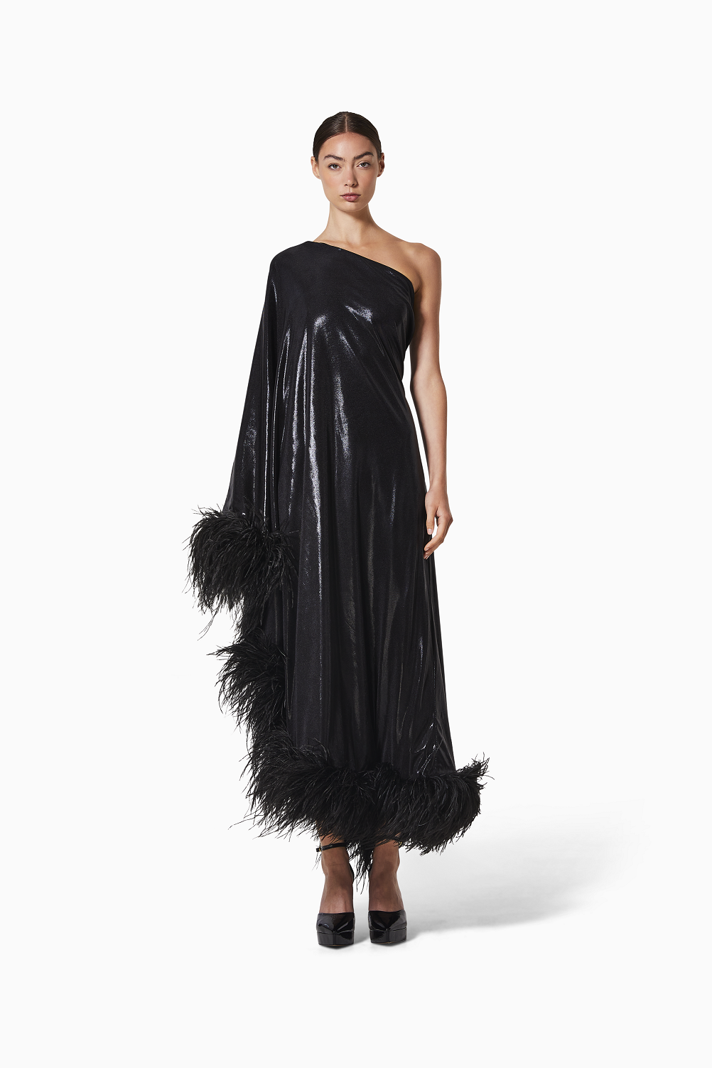 Woman wearing a black one-shoulder dress with feather details on a white background